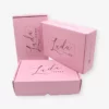 corrugated boxes printed in pink color with black text